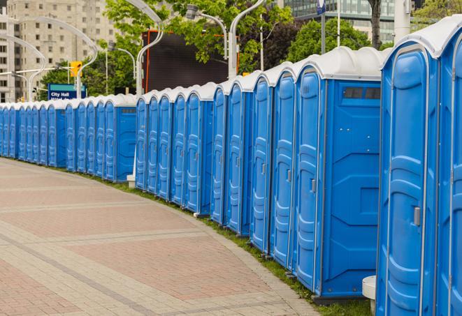 portable restrooms stationed outside of a high-profile event, with attendants available for assistance in Franklin Square